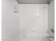 Bright white tiled shower with built-in soap and shampoo dispenser at 517 Casa Del Norte Dr, North Las Vegas, NV 89031