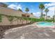 Well landscaped backyard with a kidney shaped pool and patio area at 5205 Coral Glow Ct, Las Vegas, NV 89149