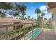 Balcony overlooking community pool, lush landscaping, and palm trees at 5205 Coral Glow Ct, Las Vegas, NV 89149