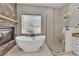 Luxurious bathroom with freestanding tub, stone fireplace, and elegant shower with mosaic tile at 5205 Coral Glow Ct, Las Vegas, NV 89149