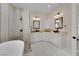 Modern bathroom with dual vanities, vessel sinks, a soaking tub, and a walk-in shower at 5205 Coral Glow Ct, Las Vegas, NV 89149