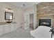 Spa-like bathroom featuring a tub, stone fireplace, and granite countertop at 5205 Coral Glow Ct, Las Vegas, NV 89149