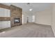 Large bedroom featuring a stone fireplace, built-in cabinets, and neutral carpeting at 5205 Coral Glow Ct, Las Vegas, NV 89149