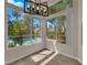 Bright dining area featuring large windows with views of backyard pool and mature trees and landscaping at 5205 Coral Glow Ct, Las Vegas, NV 89149