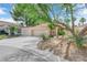Well-maintained home featuring a two-car garage, xeriscaped front yard, and mature desert landscaping at 5205 Coral Glow Ct, Las Vegas, NV 89149