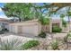 Charming home with an attached two-car garage, complemented by desert landscaping and a welcoming entrance at 5205 Coral Glow Ct, Las Vegas, NV 89149