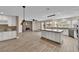 Open concept kitchen with an island, granite countertops, stainless appliances and wood flooring at 5205 Coral Glow Ct, Las Vegas, NV 89149