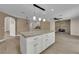 Kitchen featuring granite countertops, a center island and views into the living room at 5205 Coral Glow Ct, Las Vegas, NV 89149