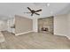 Open living room with a brick fireplace, wood floors, and a view into the kitchen at 5205 Coral Glow Ct, Las Vegas, NV 89149