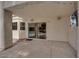 Covered patio with concrete flooring looks out through sliding glass doors towards the home's pool at 5205 Coral Glow Ct, Las Vegas, NV 89149