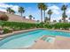 Kidney shaped pool and hot tub surrounded by lush landscaping at 5205 Coral Glow Ct, Las Vegas, NV 89149