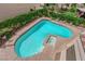 Aerial view of a kidney shaped pool and attached hot tub in backyard at 5205 Coral Glow Ct, Las Vegas, NV 89149