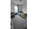Bedroom with bed and toys with neutral gray carpet and plenty of natural light at 5209 Silica Chalk Ave, Las Vegas, NV 89115