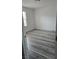 Clean, empty bedroom with gray floors, white walls, and natural light from the window at 5209 Silica Chalk Ave, Las Vegas, NV 89115