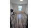 Bright bedroom featuring stylish wood-look flooring, a window for natural light, and ample space at 5209 Silica Chalk Ave, Las Vegas, NV 89115
