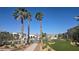 Community space with pool, palm trees, lush landscaping, and buildings at 5209 Silica Chalk Ave, Las Vegas, NV 89115