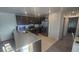Modern kitchen features stainless steel appliances, dark wood cabinets, and granite countertops at 5209 Silica Chalk Ave, Las Vegas, NV 89115