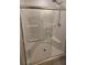 Modern shower featuring sleek glass doors, tiled walls, and a convenient built-in seat at 5209 Silica Chalk Ave, Las Vegas, NV 89115