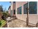 Desert backyard features a bench, neutral colored stucco wall, and well placed windows at 6121 Mission Gorge Ct, Las Vegas, NV 89130