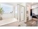 Bright main bathroom with a bathtub, separate glass shower, and new vanity at 6121 Mission Gorge Ct, Las Vegas, NV 89130