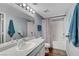 This bathroom features a large vanity, a big mirror, and a shower-tub combination at 6650 W Warm Springs Rd # 1083, Las Vegas, NV 89118