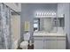 Well-lit bathroom with white cabinets, mirror, shower and toilet at 6650 W Warm Springs Rd # 1083, Las Vegas, NV 89118