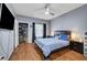 Comfortable bedroom features wood-look floors, a ceiling fan, and an open closet at 6650 W Warm Springs Rd # 1083, Las Vegas, NV 89118
