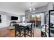 Open concept to living room, the dining area has a modern table and access to a patio at 6650 W Warm Springs Rd # 1083, Las Vegas, NV 89118