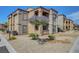 Two-story apartment complex with desert landscaping features stairways and private balconies at 6650 W Warm Springs Rd # 1083, Las Vegas, NV 89118