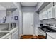 Well-lit kitchen featuring white cabinets, stainless steel appliances, and wood-look flooring at 6650 W Warm Springs Rd # 1083, Las Vegas, NV 89118