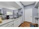 Kitchen with sink, dishwasher, and white cabinets, and open to the dining area at 6650 W Warm Springs Rd # 1083, Las Vegas, NV 89118
