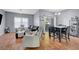 Spacious living room and dining area with wood-look floors and contemporary furniture at 6650 W Warm Springs Rd # 1083, Las Vegas, NV 89118