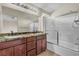 Bathroom featuring dual sinks, granite countertop, and shower tub at 682 E Sole Addiction Ave, Las Vegas, NV 89183
