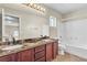 Bathroom with dual sinks, granite countertop, and tub shower at 682 E Sole Addiction Ave, Las Vegas, NV 89183