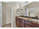 Bathroom with dual sinks, granite countertop, and shower access at 682 E Sole Addiction Ave, Las Vegas, NV 89183