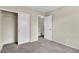 Bedroom featuring a closet with sliding doors and neutral carpet at 682 E Sole Addiction Ave, Las Vegas, NV 89183