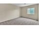 Bright bedroom featuring neutral walls, carpet, and a window at 682 E Sole Addiction Ave, Las Vegas, NV 89183