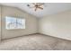 Bright, carpeted bedroom featuring high ceilings and a large window at 682 E Sole Addiction Ave, Las Vegas, NV 89183