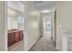 Hallway with bathroom and bedroom views, carpet, and neutral walls at 682 E Sole Addiction Ave, Las Vegas, NV 89183