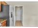 A shot of the side-by-side stainless refrigerator and open door to the laundry room at 682 E Sole Addiction Ave, Las Vegas, NV 89183