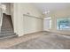 Spacious living room with high ceilings, new carpet, and tile leading to the stairway at 682 E Sole Addiction Ave, Las Vegas, NV 89183