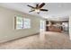 Spacious living room area with ceiling fan, open floorplan, and abundant natural light at 682 E Sole Addiction Ave, Las Vegas, NV 89183