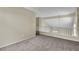Carpeted loft area with natural light, neutral walls, and a railing at 682 E Sole Addiction Ave, Las Vegas, NV 89183