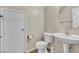 A pedestal sink and low flow toilet in the downstairs powder room at 682 E Sole Addiction Ave, Las Vegas, NV 89183