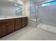 Modern bathroom with double sinks, a large mirror, and a glass-enclosed shower for a luxurious feel at 6918 Dandelion Park Ave, Las Vegas, NV 89113