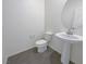 A sleek powder room features a pedestal sink and grey tile floors at 6918 Dandelion Park Ave, Las Vegas, NV 89113