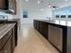Modern kitchen with stainless steel appliances, granite countertops, and ample counter space for cooking at 6918 Dandelion Park Ave, Las Vegas, NV 89113