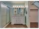 Bathroom featuring a double sink vanity, shower, and tile floors at 7240 Wandering Star Ct, Las Vegas, NV 89131