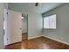Bedroom featuring hardwood floors, a fan, and a mirrored closet at 7240 Wandering Star Ct, Las Vegas, NV 89131