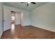 Bedroom with wood-look floors, ceiling fan, and a doorway to another room at 7240 Wandering Star Ct, Las Vegas, NV 89131